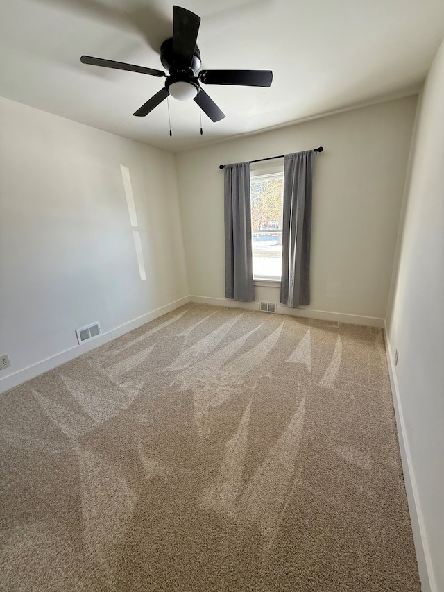 carpeted spare room with ceiling fan