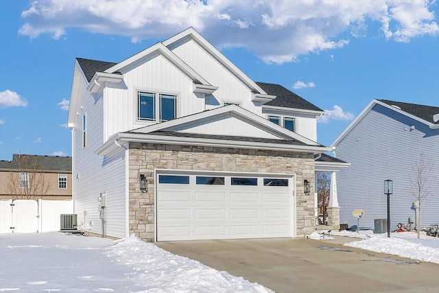 craftsman-style home featuring a garage and cooling unit