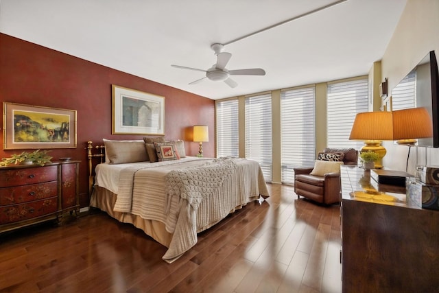 bedroom with ceiling fan and dark wood-type flooring