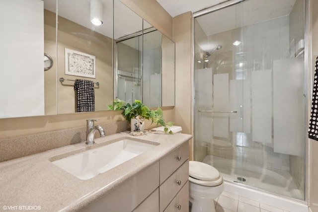 bathroom with vanity, a shower with shower door, and toilet