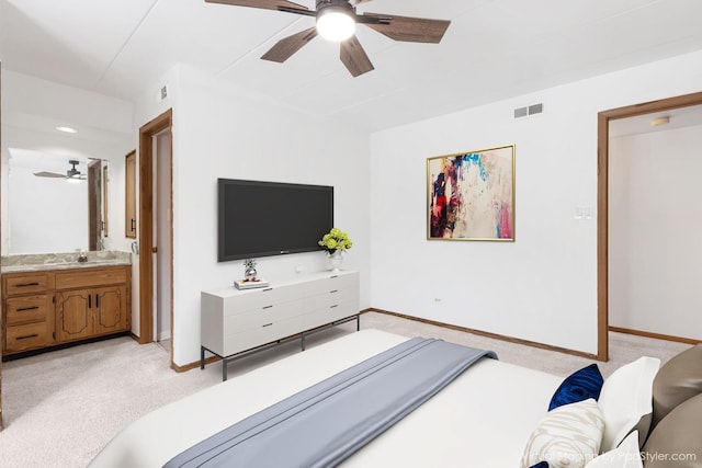 bedroom featuring ceiling fan, light colored carpet, sink, and connected bathroom