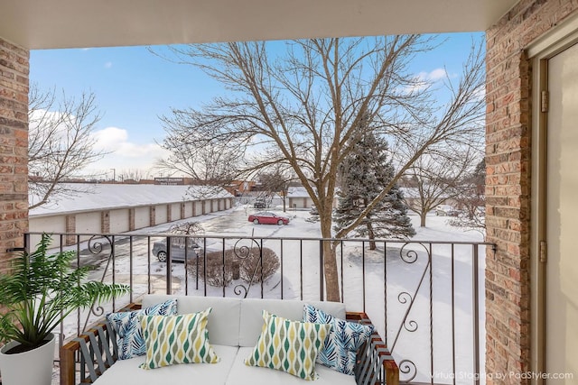 snow covered back of property featuring an outdoor hangout area