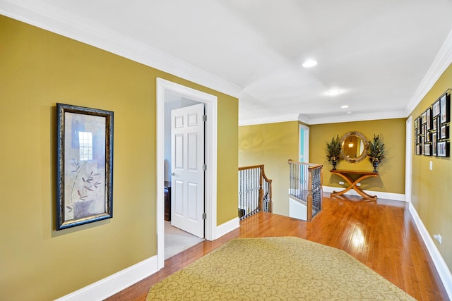 corridor featuring hardwood / wood-style flooring and crown molding