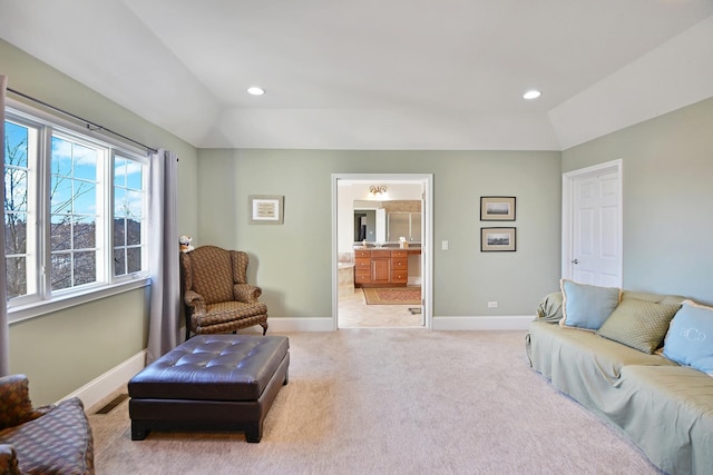 living room with vaulted ceiling and light colored carpet