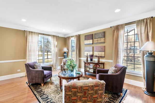 sitting room with crown molding and hardwood / wood-style floors