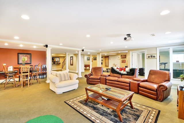 living room featuring ornate columns and light carpet