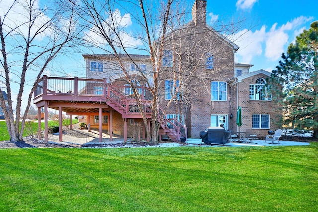 rear view of property with a wooden deck, a yard, and a patio area