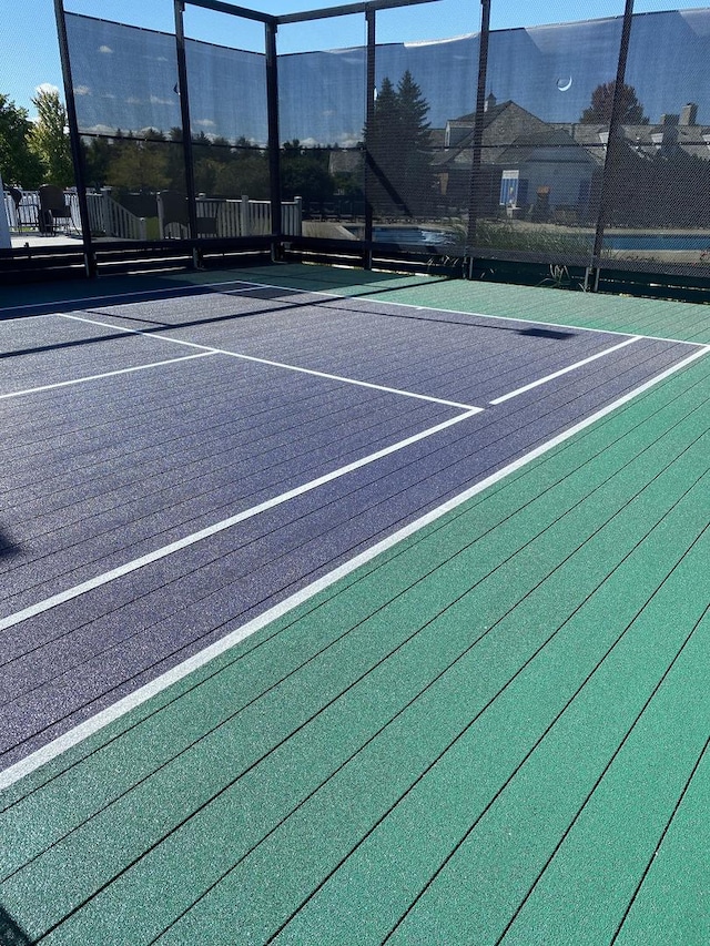 view of tennis court featuring a mountain view