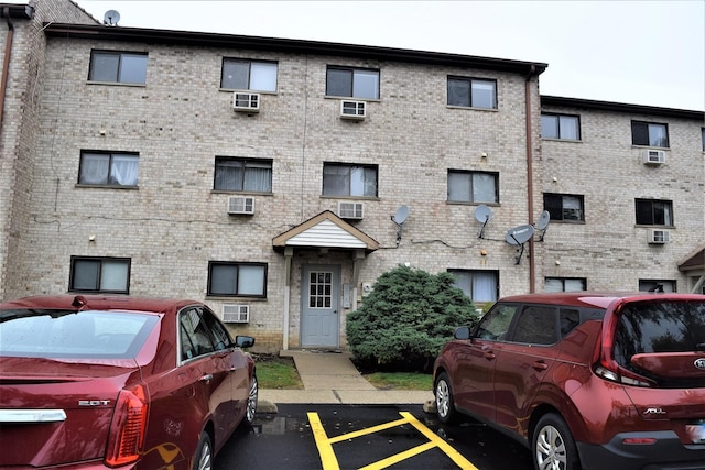 view of building exterior with a wall unit AC