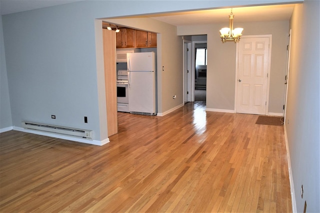 interior space featuring a baseboard radiator, an inviting chandelier, and light hardwood / wood-style floors