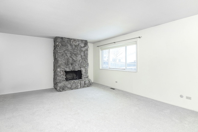 unfurnished living room with a fireplace and carpet floors