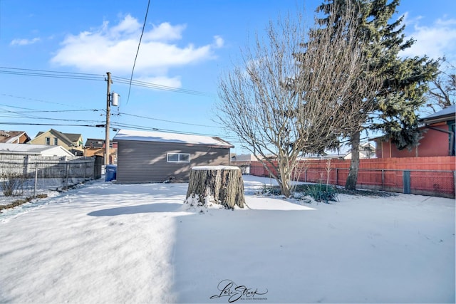 yard covered in snow with an outdoor structure