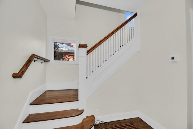 stairs featuring hardwood / wood-style floors