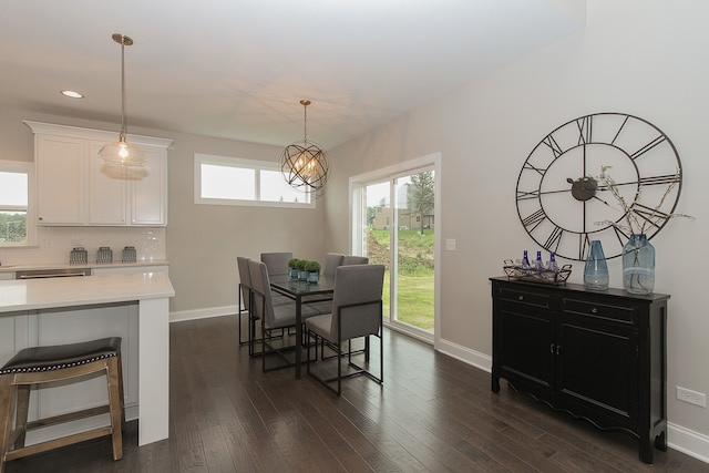 dining area featuring dark hardwood / wood-style floors and a notable chandelier