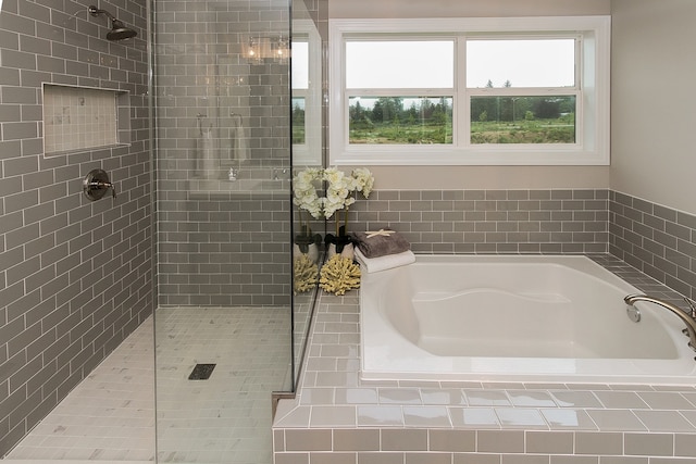 bathroom featuring shower with separate bathtub