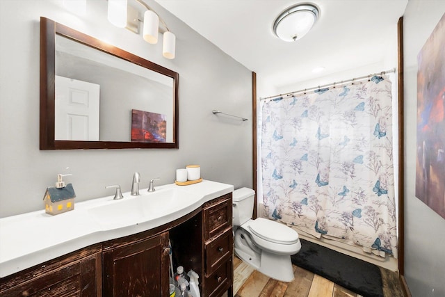 full bathroom featuring hardwood / wood-style flooring, toilet, vanity, and shower / bath combo with shower curtain