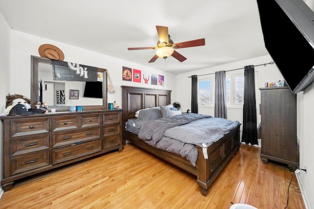 bedroom with light wood-type flooring and ceiling fan