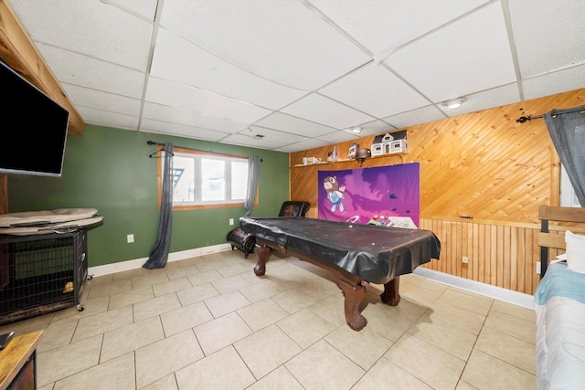 game room with light tile patterned floors, a drop ceiling, billiards, and wood walls