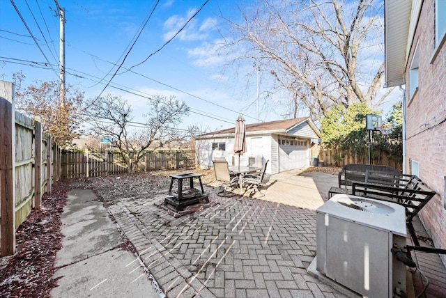 view of patio / terrace with an outbuilding and a garage