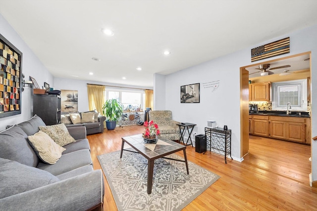 living room featuring sink and light wood-type flooring