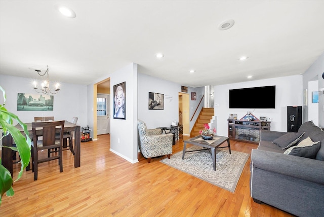 living room featuring a chandelier and light hardwood / wood-style flooring