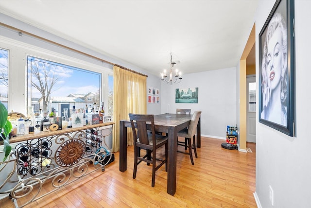 dining room featuring an inviting chandelier and light wood-type flooring