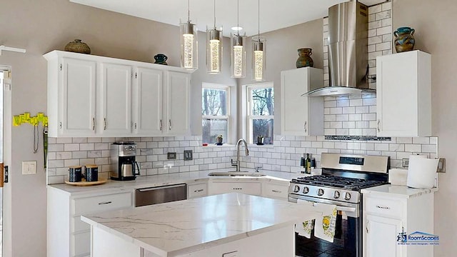 kitchen with sink, white cabinets, hanging light fixtures, stainless steel appliances, and wall chimney exhaust hood