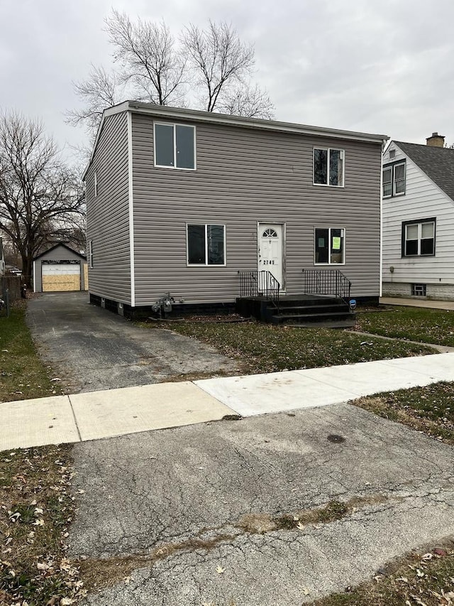 view of front of home with a garage and an outdoor structure