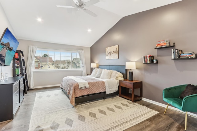 bedroom with hardwood / wood-style flooring, ceiling fan, and lofted ceiling