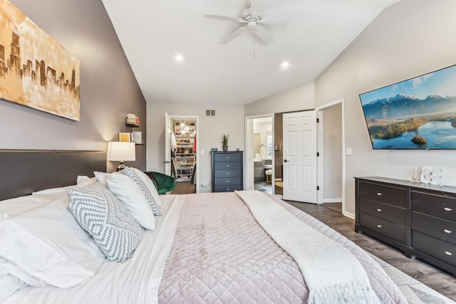 bedroom featuring hardwood / wood-style floors, lofted ceiling, a spacious closet, ensuite bath, and a closet