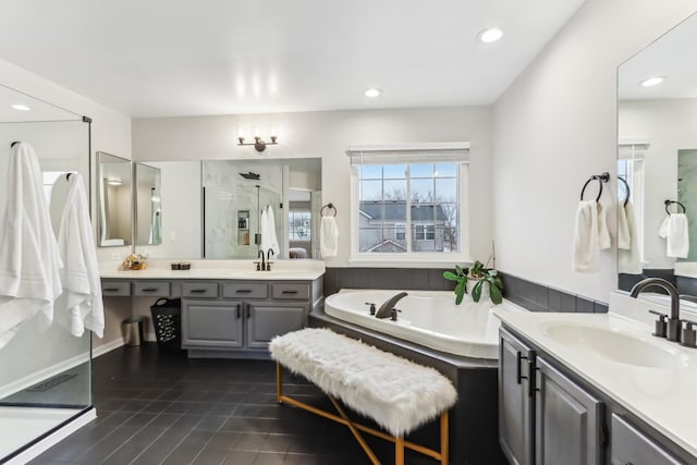 bathroom with tile patterned flooring, vanity, and shower with separate bathtub