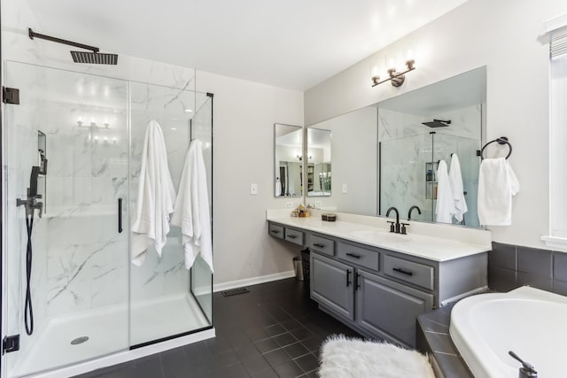 bathroom with vanity and shower with separate bathtub