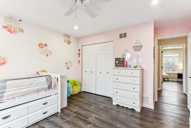 bedroom featuring dark wood-type flooring, ceiling fan, and a closet