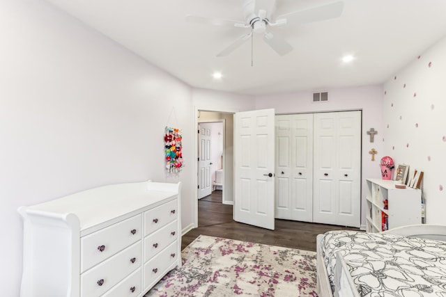 bedroom featuring dark wood-type flooring, a closet, and ceiling fan