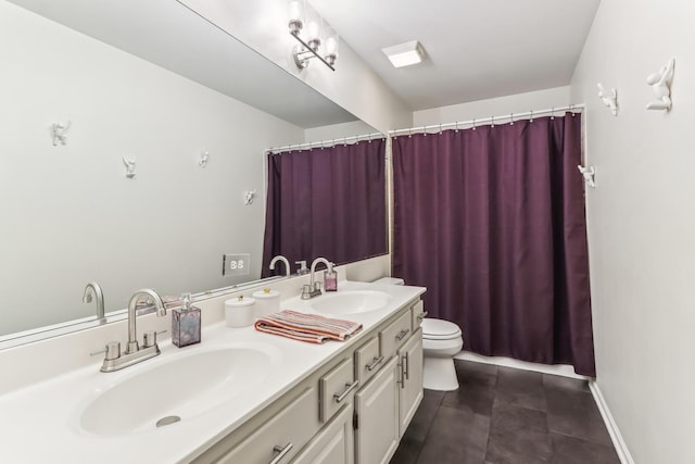 bathroom with vanity, tile patterned floors, and toilet