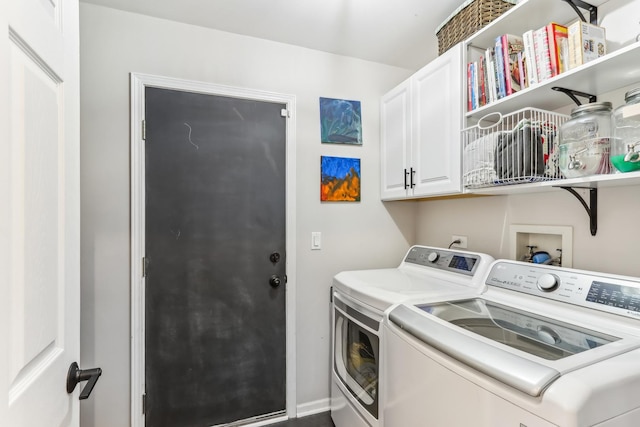 laundry room with cabinets and washer and clothes dryer