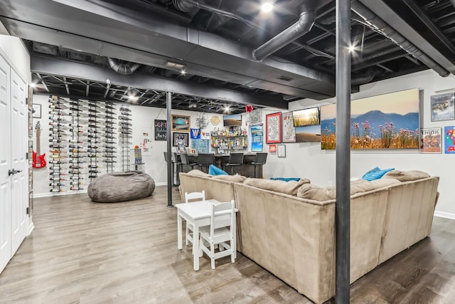 interior space with indoor bar and hardwood / wood-style floors