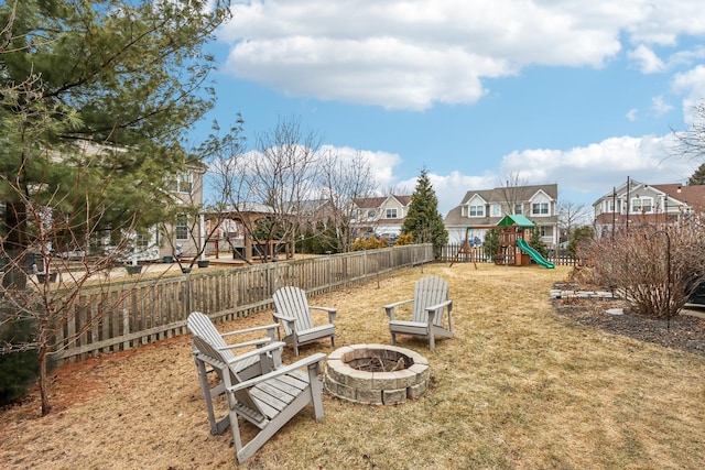 view of yard featuring a playground and a fire pit