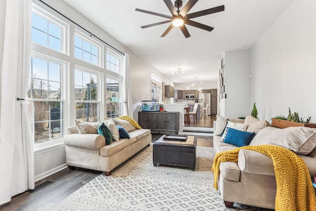 living room featuring ceiling fan and light hardwood / wood-style floors