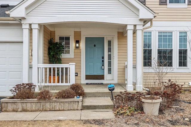 view of exterior entry with a garage