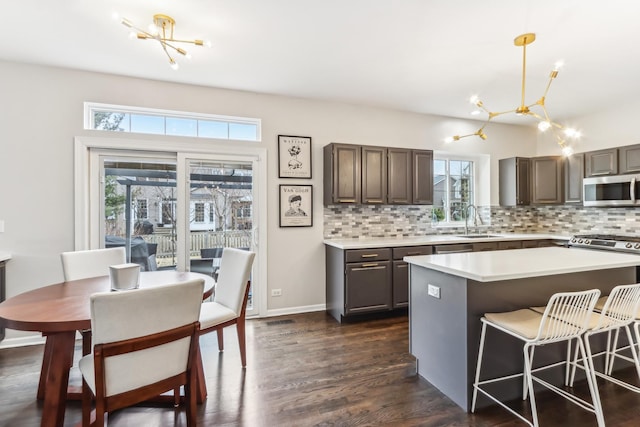 kitchen with a notable chandelier, decorative light fixtures, sink, and a kitchen island