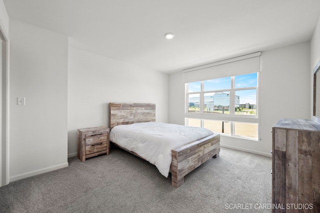 carpeted bedroom featuring baseboards