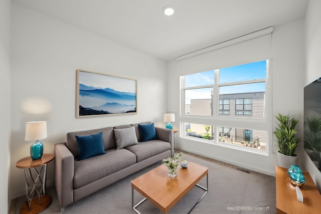 living area with visible vents, baseboards, and recessed lighting