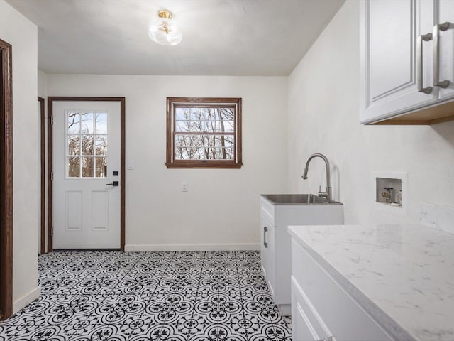 washroom featuring cabinets, sink, and hookup for a washing machine