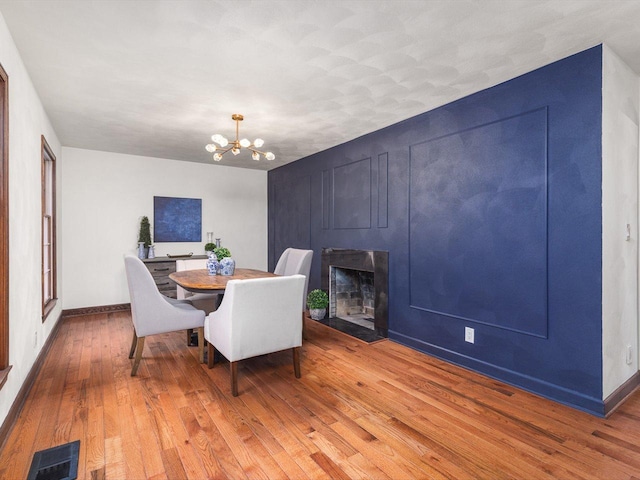 dining room featuring wood-type flooring and a notable chandelier