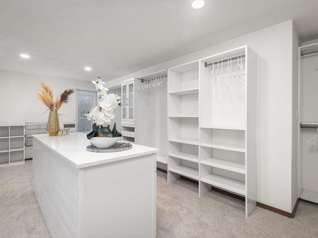 spacious closet with light colored carpet