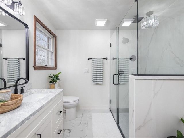 bathroom with vanity, toilet, and a shower with door