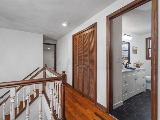 hallway featuring dark hardwood / wood-style flooring and sink