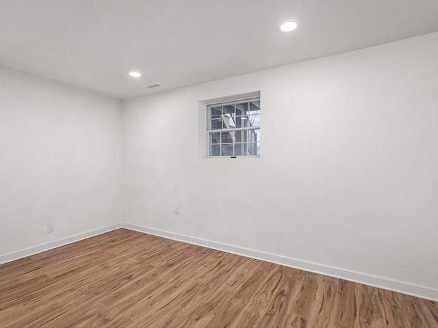 empty room with hardwood / wood-style flooring