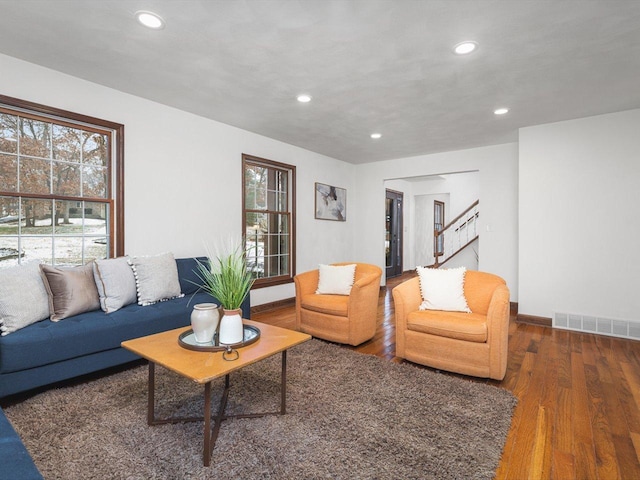 living room with dark hardwood / wood-style flooring